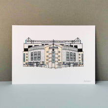 Load image into Gallery viewer, A Chelsea Stadium Print. The piece is a detailed illustration of Stamford Bridge in fineliner and watercolours. Printed on thick paper, photographed against a grey background.