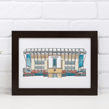 Load image into Gallery viewer, A piece of Leeds United wall art. The artwork is a fineliner and watercolour print of the artist&#39;s hand drawn piece. It&#39;s photographed in a black frame against a white brick wall.
