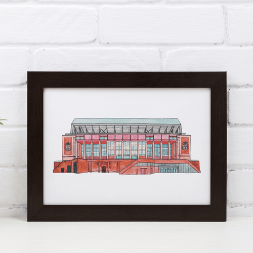 A detailed Liverpool Football print of the Anfield stadium. The piece is painting in watercolour and fineliner and signed by the artist. It's photographed in a white frame.