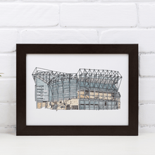 Load image into Gallery viewer, Newcastle United Football Stadium print, a detailed illustration of St James' Park hand drawn and painted by the artist Jessica Sian. The piece is in a black frame against a white brick wall.