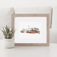 Load image into Gallery viewer, A framed illustration of Meadow Lane, the football ground home to Notts County. The piece is in a wooden frame, sat on a coffee table next to a small succulent.