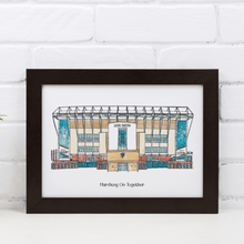 Load image into Gallery viewer, A personalised Leeds United art print. The piece has the words 'Marching On Together' printed underneath it. It is in a white frame, photographed against a white brick wall.