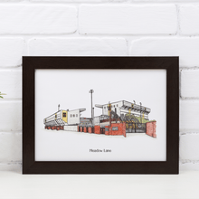 Load image into Gallery viewer, Personalised Notts County wall art of the club's football stadium with the words 'Meadow Lane' printed underneath. Framed in a black frame, photographed against a white brick wall.