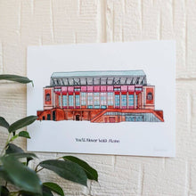 Load image into Gallery viewer, A Liverpool FC Print of the club's football stadium. It shows a painted image of Anfield. The piece is displayed on a white brick wall with a plant in the lower left corner.