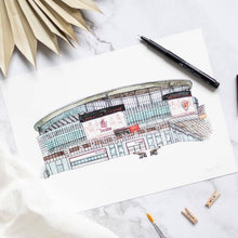 Load image into Gallery viewer, Arsenal art print of the Emirates stadium, the piece is on a marble table with a fineliner pen beside it.

