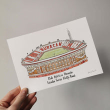 Load image into Gallery viewer, A pen and watercolour illustration of the Buenos Aires football stadium Estadio Toma Adolfo Duco. The piece is painted on A5 paper and is held up against a pale grey wall.
