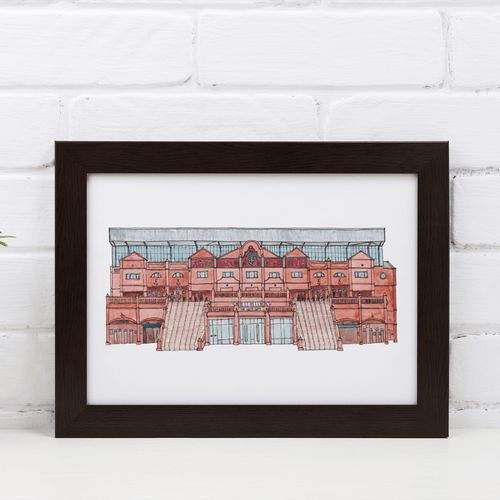 A detailed illustration of Aston Villa Football Stadium. The piece is in a black frame against a white brick wall.