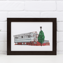 Load image into Gallery viewer, A framed print of Nottingham Forest Football Stadium, the detailed illustration is hand drawn by the artist Jessica Sian. The print is signed by the artist and photographed in a black frame.
