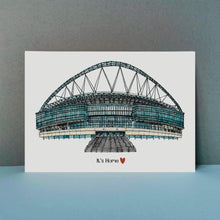 Load image into Gallery viewer, A detailed pen and watercolour print of Wembley stadium with the text &#39;It&#39;s Home&#39; and a love heart underneath.
