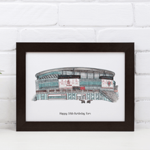 Load image into Gallery viewer, A full colour print of Arsenal Football Club&#39;s stadium. The piece has been personalised with the message &#39;Happy 18th Birthday Tom&#39; printed underneath. It is in a white frame against a white wall on a white table.
