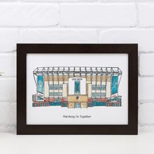 Load image into Gallery viewer, A personalised Leeds United art print. The piece has the words &#39;Marching On Together&#39; printed underneath it. It is in a white frame, photographed against a white brick wall.
