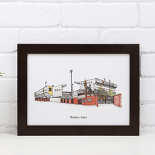 Load image into Gallery viewer, Personalised Notts County wall art of the club&#39;s football stadium with the words &#39;Meadow Lane&#39; printed underneath. Framed in a black frame, photographed against a white brick wall.
